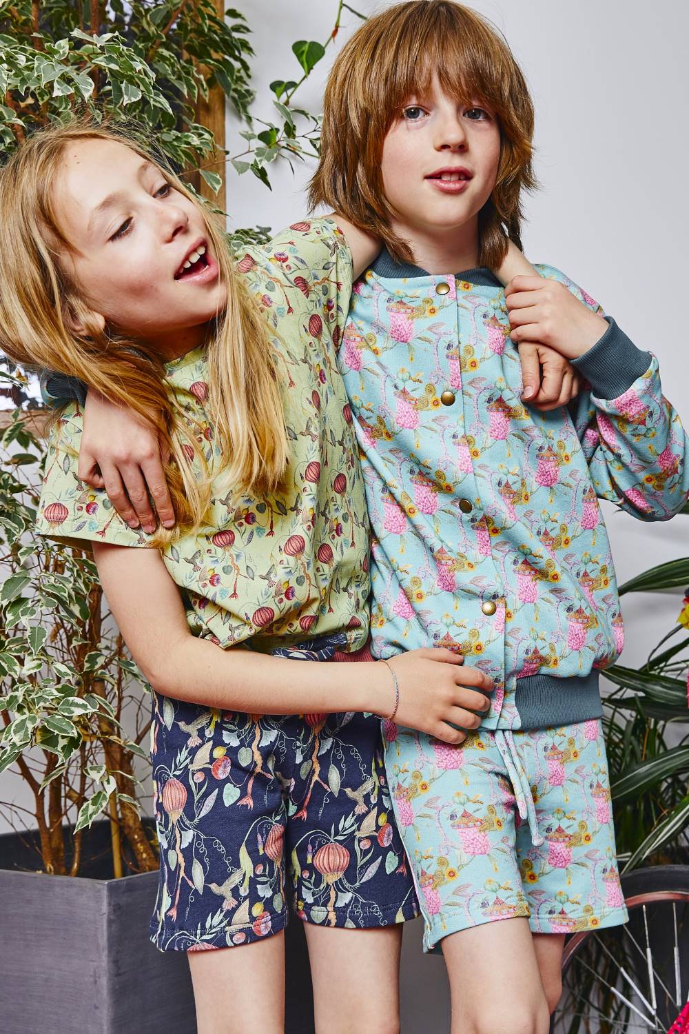 Ten years old boy and girl friends wearing printed organic cotton kids outfit by aesthete-(kids)wear.