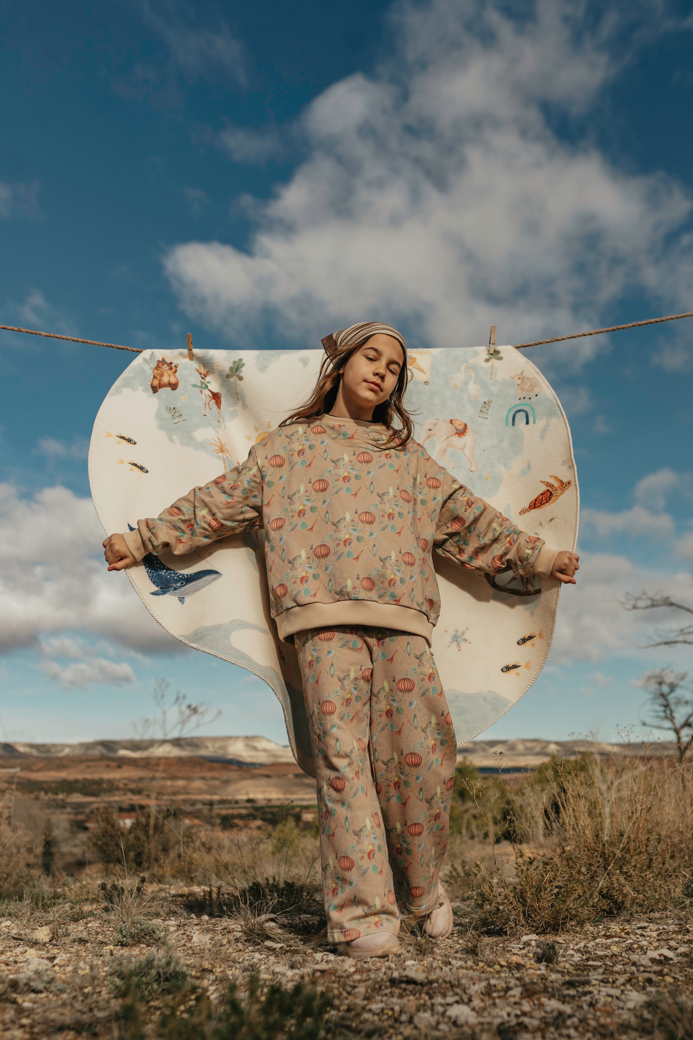 Little girl wearing 'Floral Medusa' pattern in café color kids pants and oversized sweatshirt by aesthete-(kids)wear