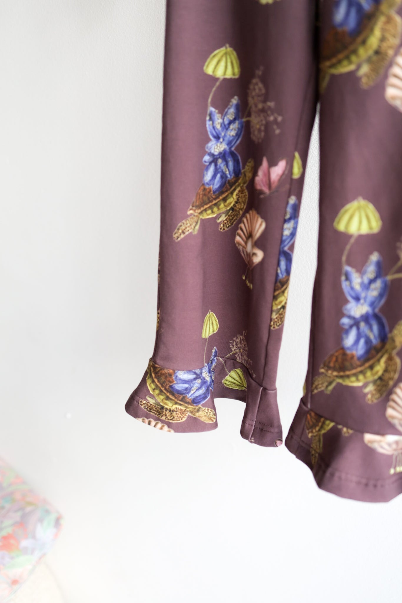 Close-up of a brown nature-patterned kids pants.