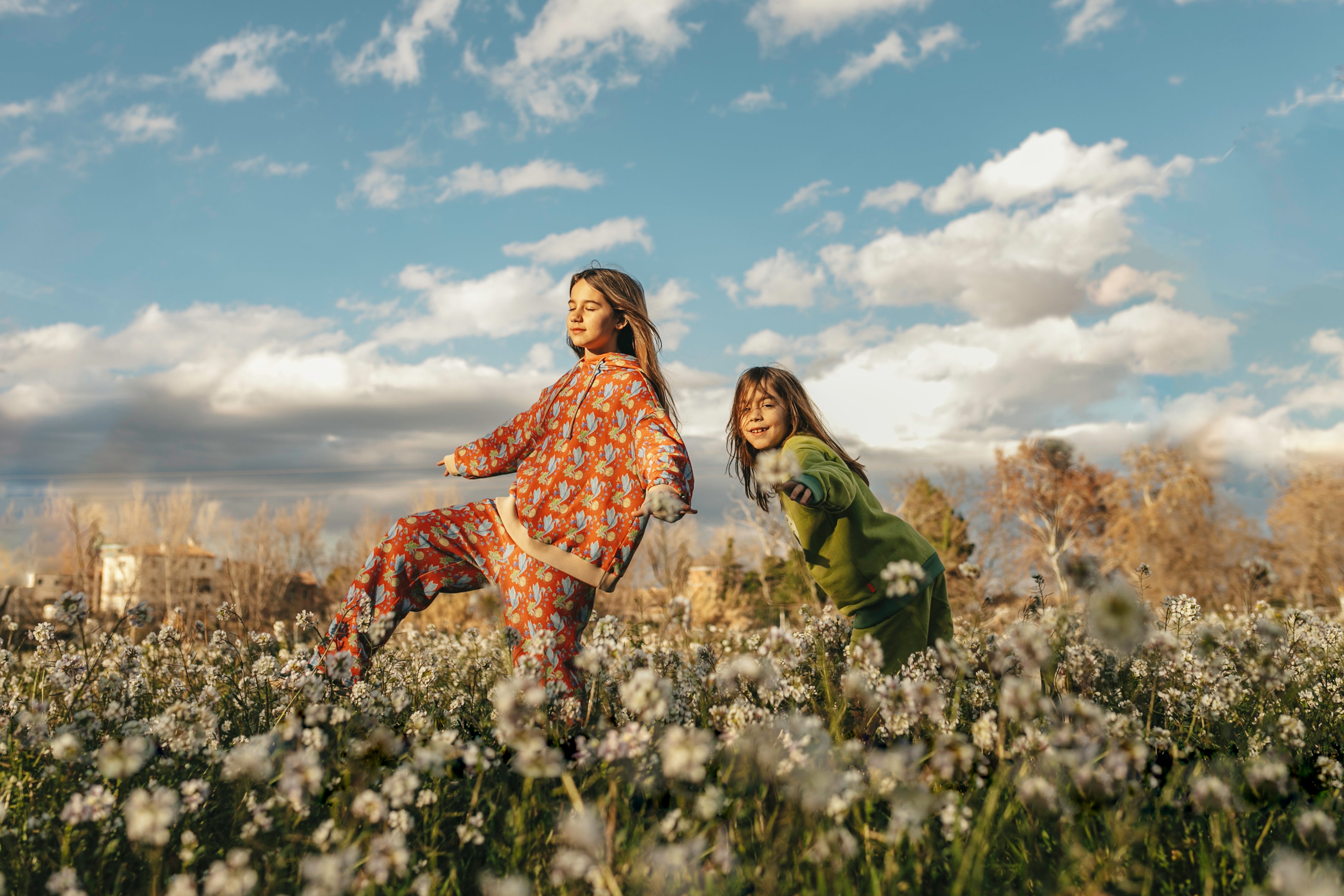 Two little girls wearing organic coton oversized hoodie, pleated pants, sweatshirt and shorts by aesthete-(kids)wear