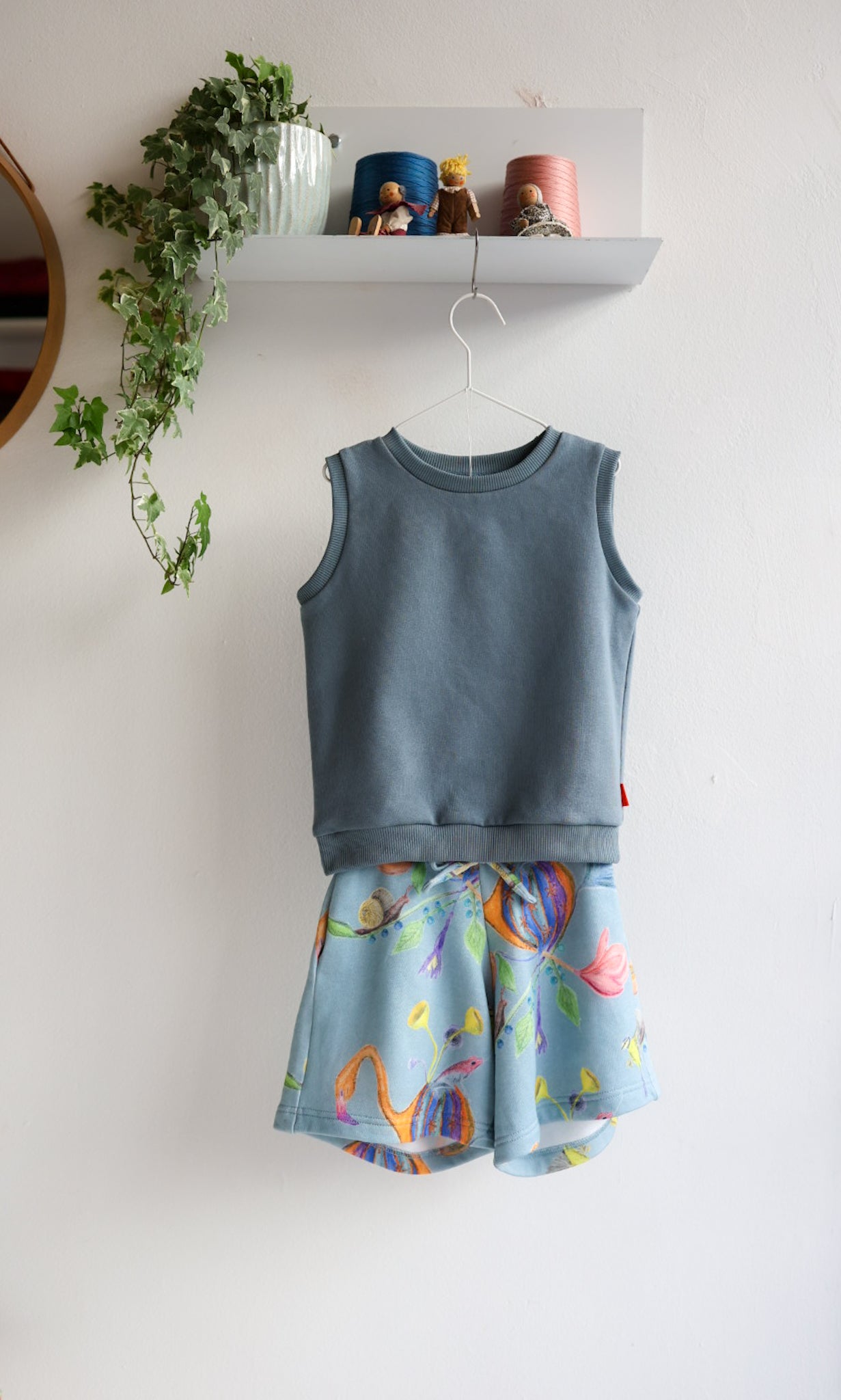 Children's sleeveless top and shorts set with colorful pattern on a white background.