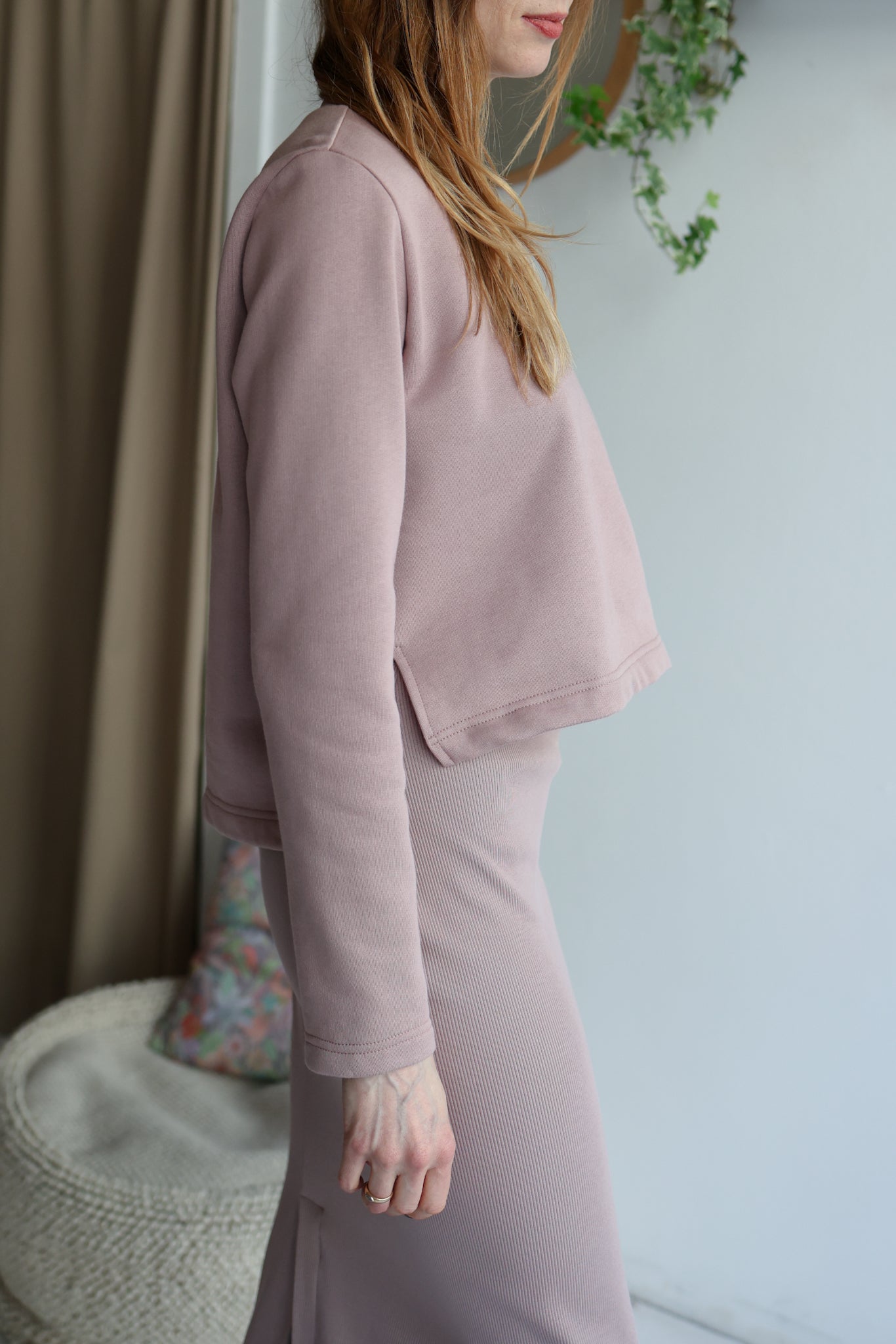 Woman wearing a pink outfit with a neutral background