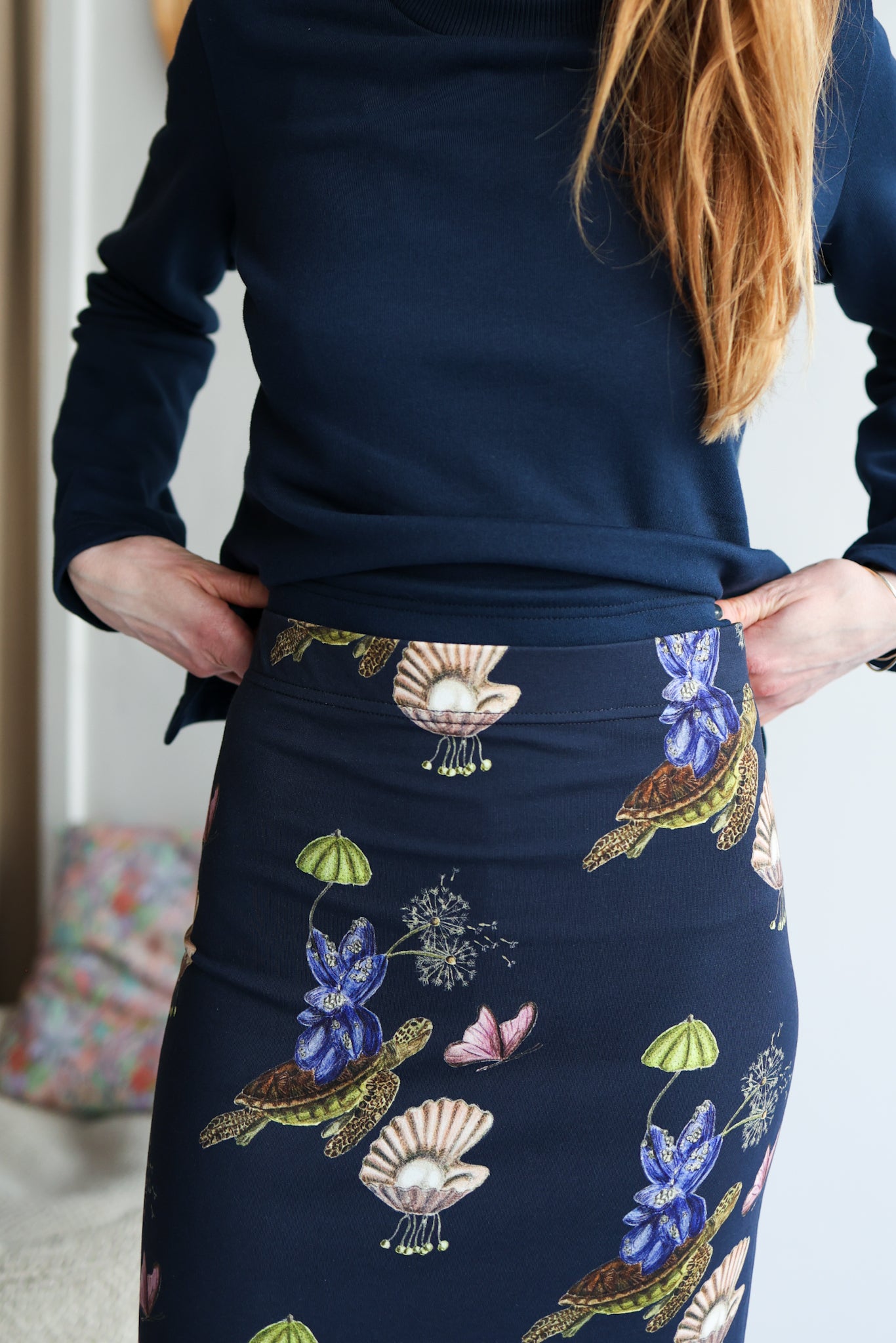 Navy skirt with nature-themed embroidery worn by a person